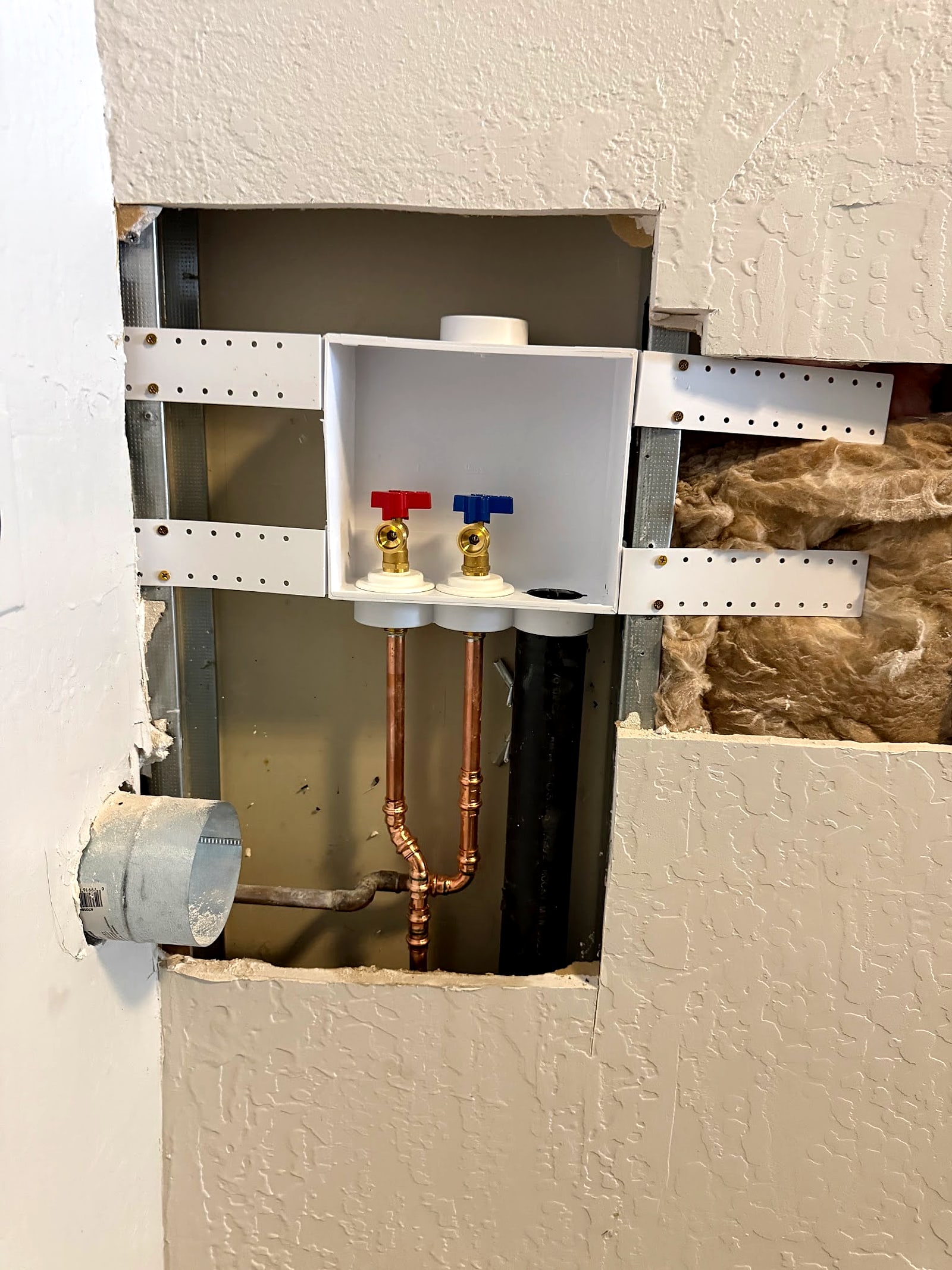 Washer box fitted between metal studs