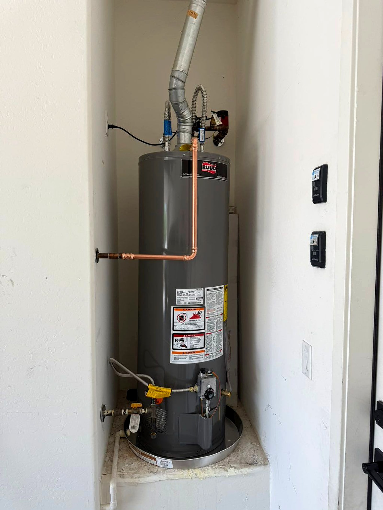 New water heater installed in a garage alcove