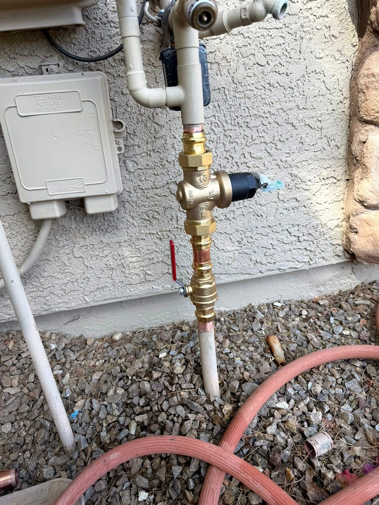 Brass valve assembly with a pressure gauge on an exterior wall
