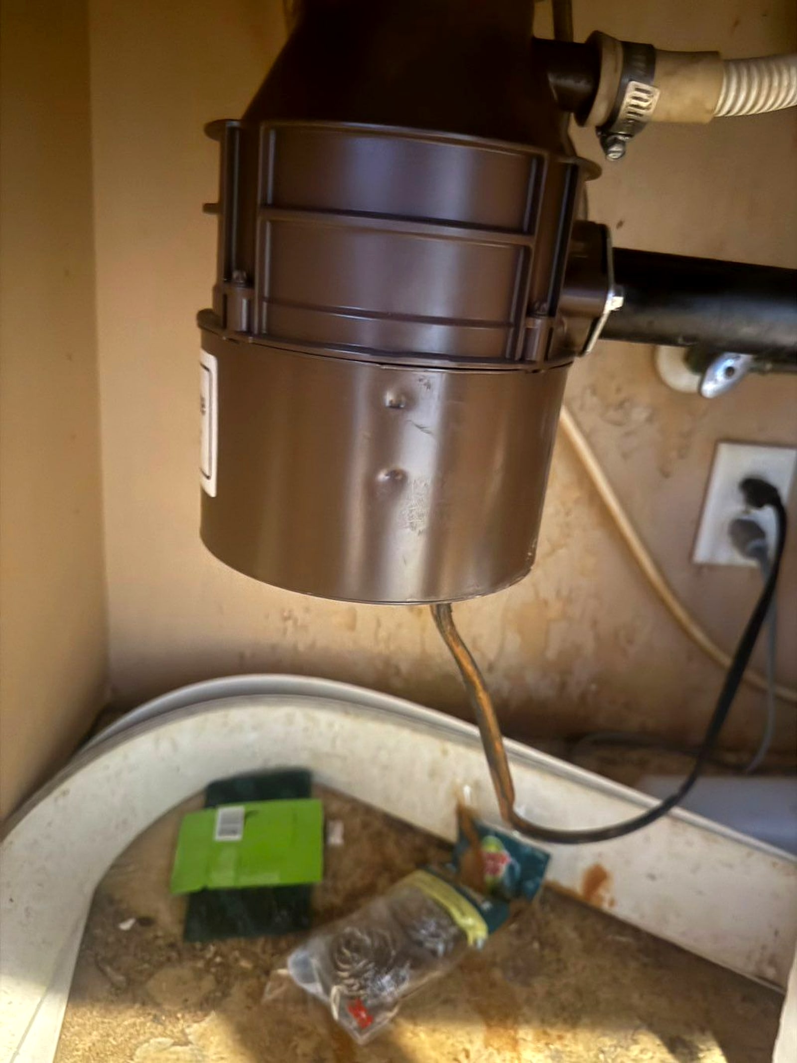 New garbage disposal installed under a kitchen sink