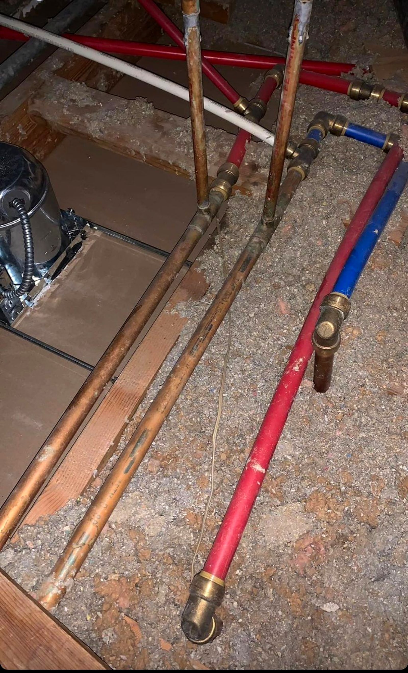New copper and PEX lines laid in an opened slab trench
